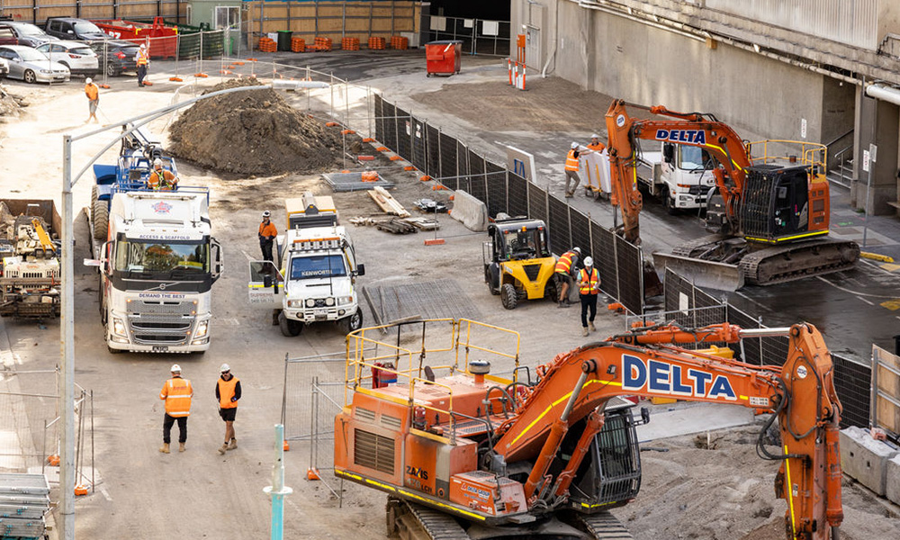 An image of construction vehicles and workers in high-vis uniforms on site at Arts Centre Melbourne